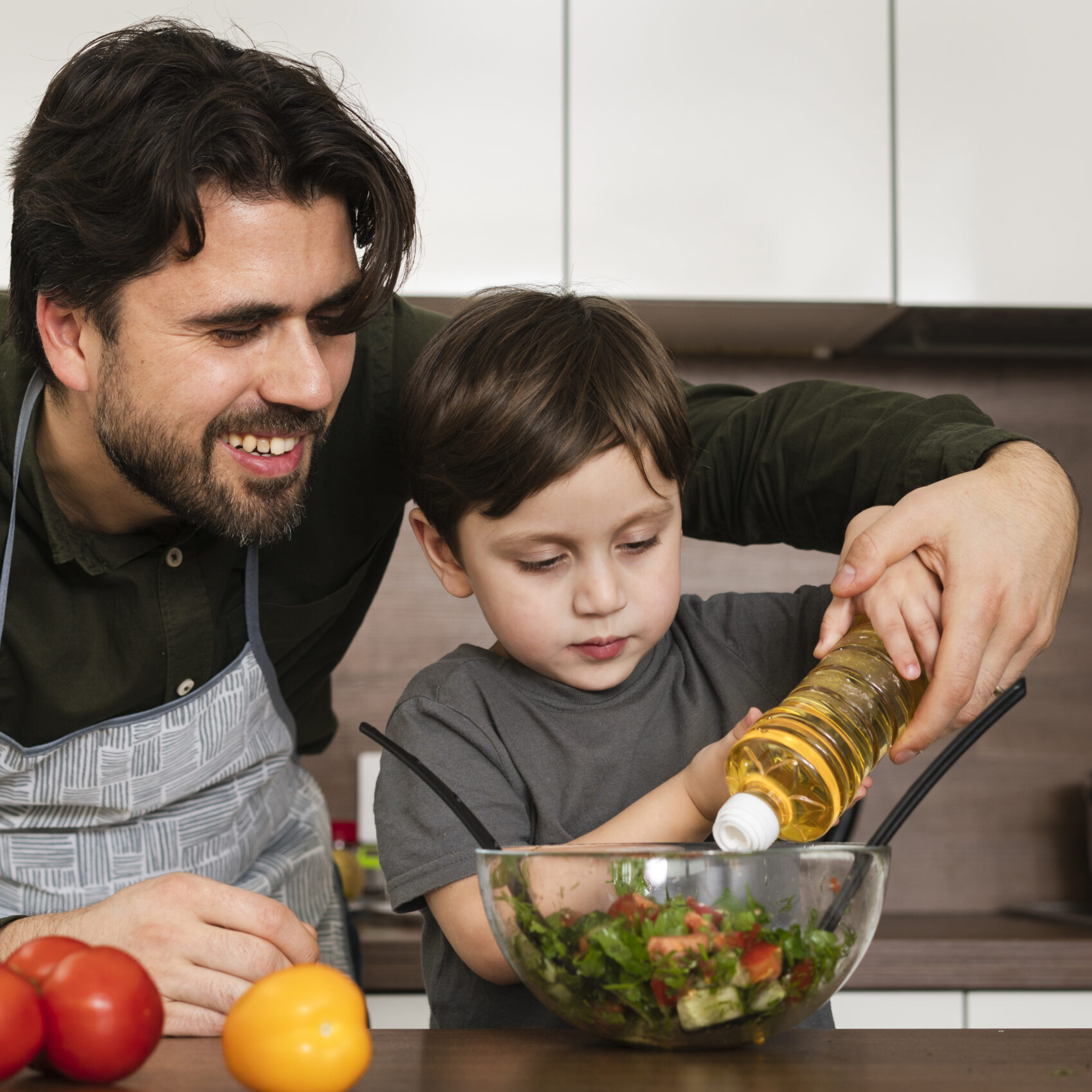 front-view-son-helping-dad-make-salad